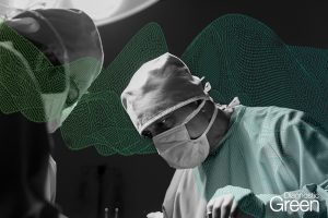 busy surgeon masked and wearing gown in operating theatre