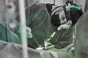male surgeon wit head torch working on patient