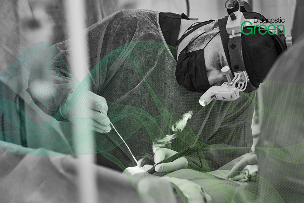 male surgeon wit head torch working on patient