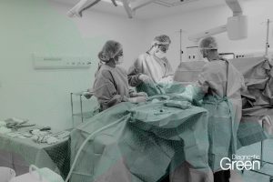 surgeon operating table with medical gown professionals